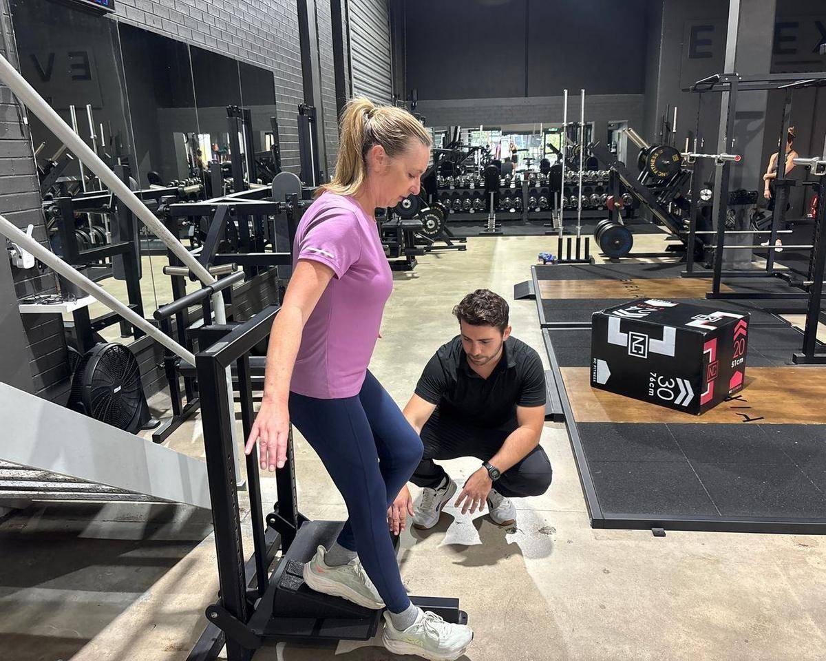 Training for Longevity — Solve PT Max coaching ankle mobility on a slant board at Solve Personal Training, Brookvale