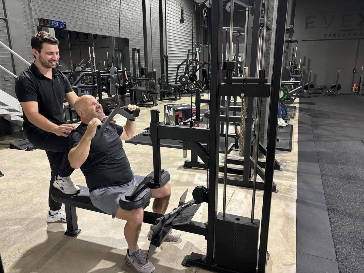 Max coaching a client one-on-one on the bench