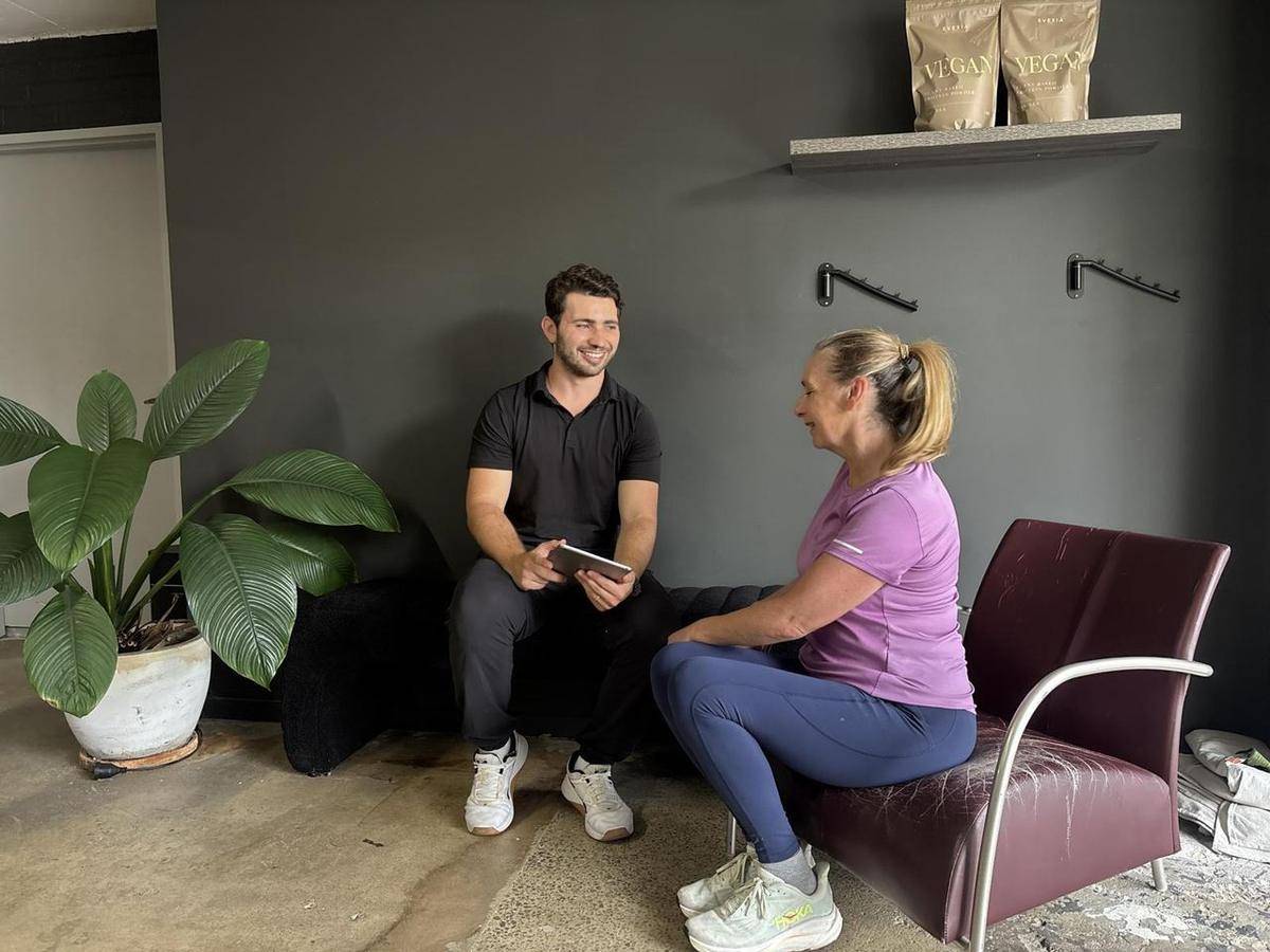 Max walking a client through training options on an iPad in the consult room
