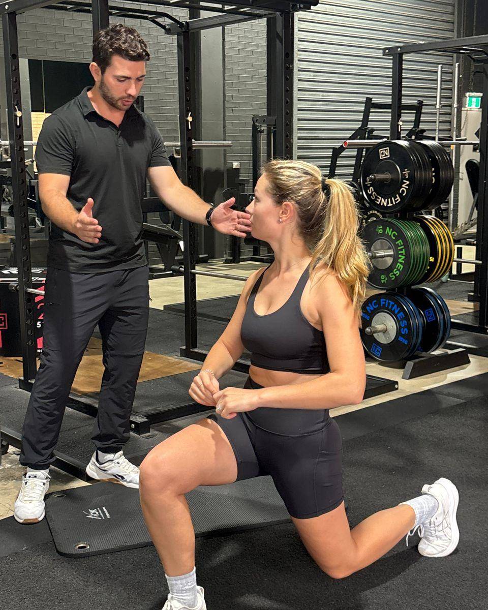 Max cueing a client through a half-kneeling position