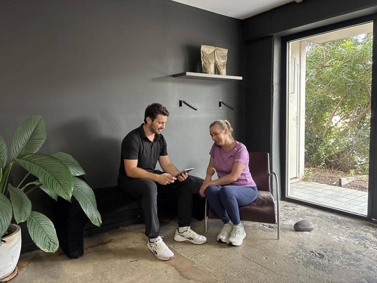 Max talking through a nutrition plan with a client in the consult room