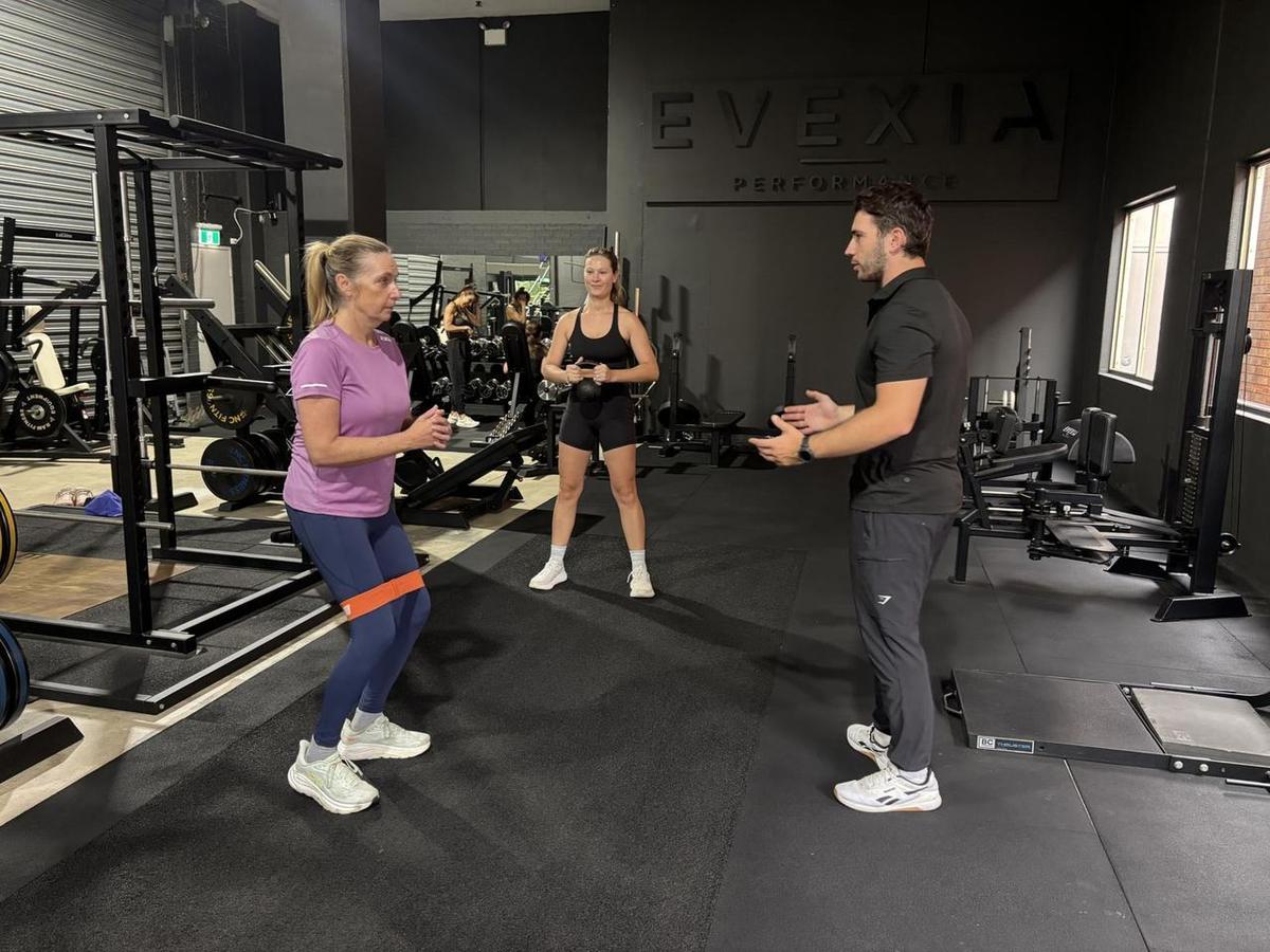 A three-person semi-private session, each client on their own program