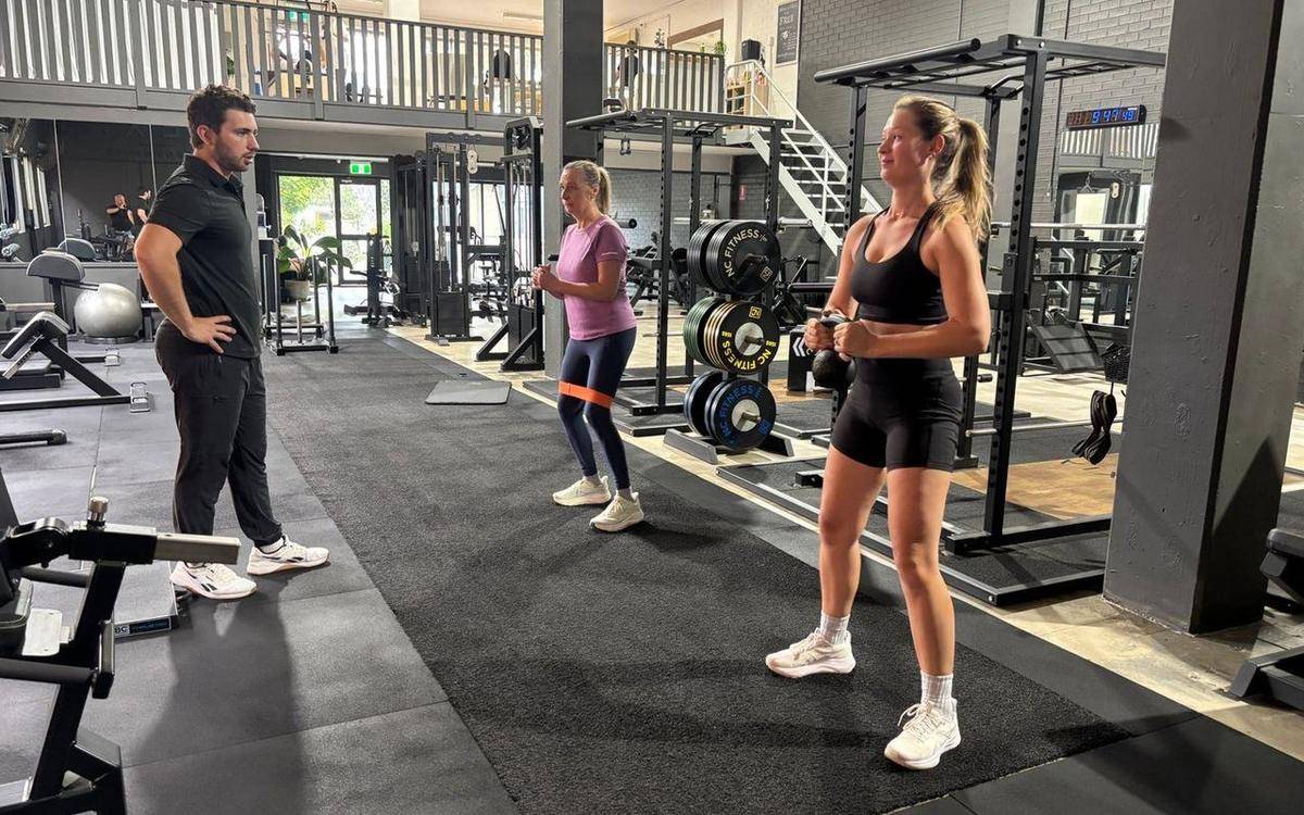 Private gym Brookvale — Solve PT Max coaching two clients at once on the training floor at Evexia Wellbeing, Brookvale