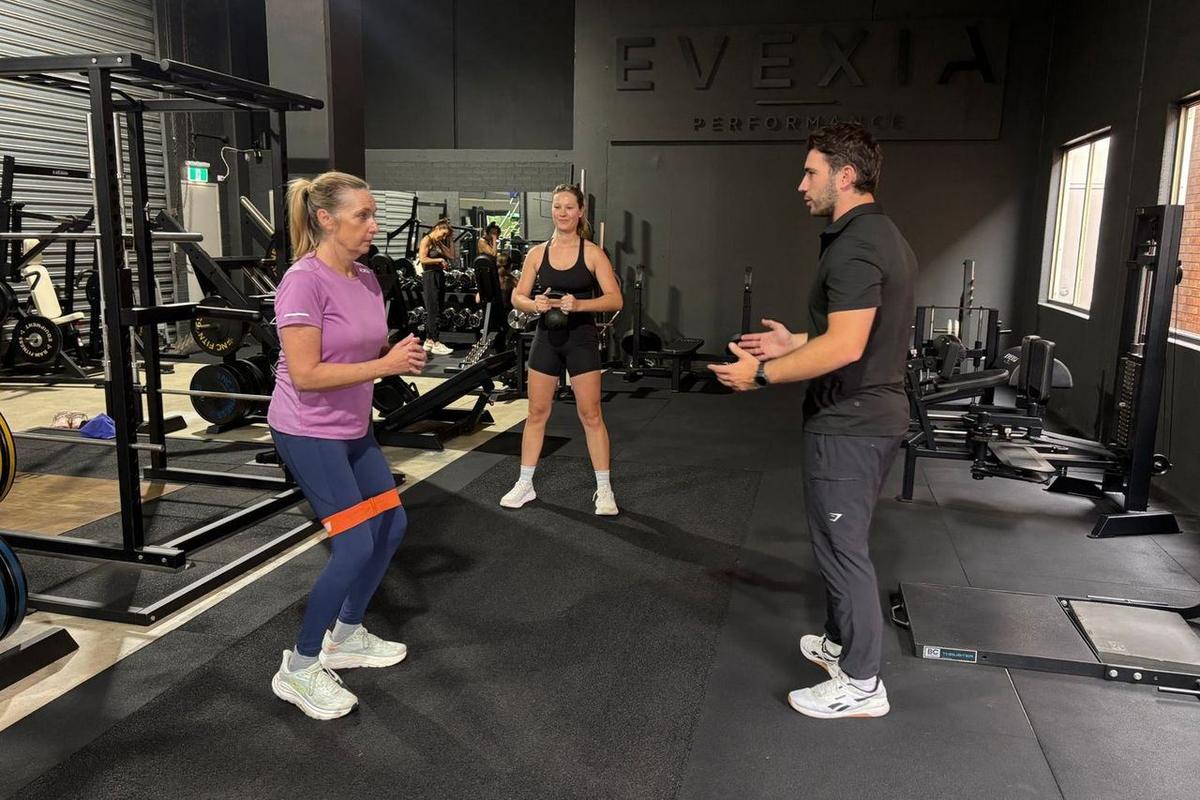 A semi-private session: two clients on their own programs, coached by Max