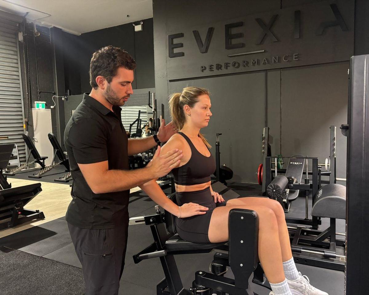 Personal Training Brookvale — Solve PT Max cueing shoulder position for a client on a seated machine at Solve Personal Training