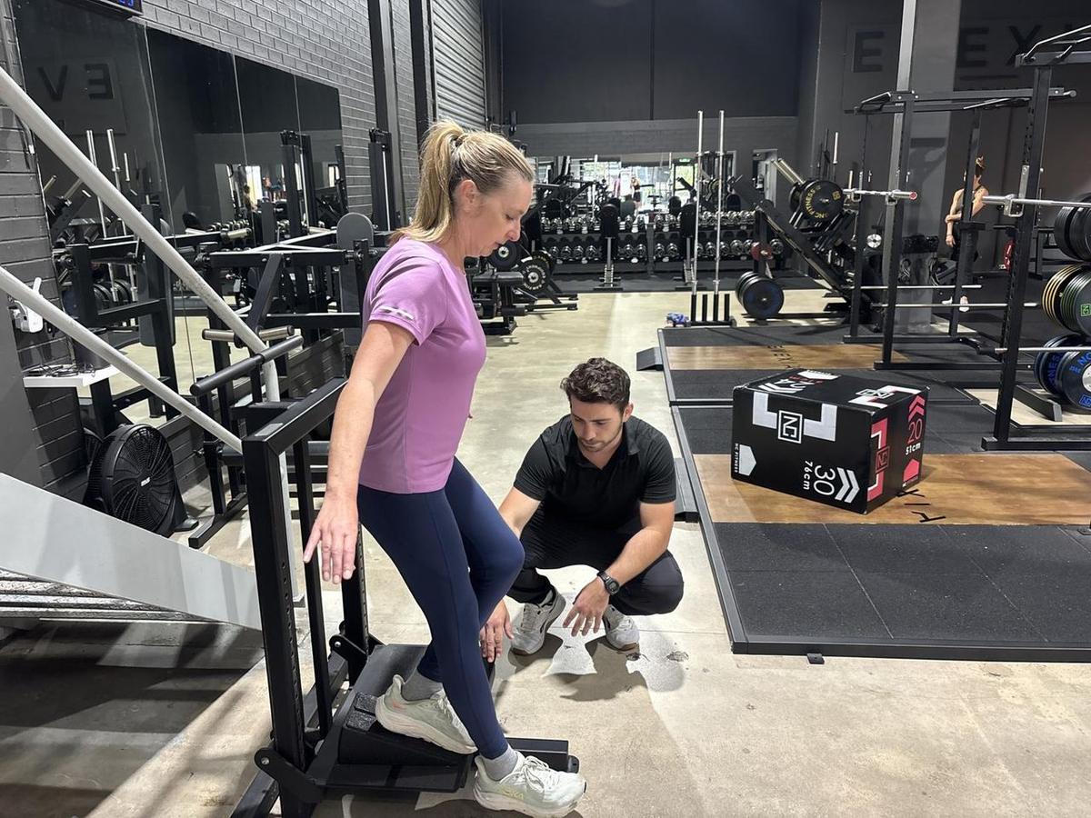 Max kneeling to cue a client’s step-up